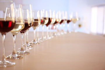 Glasses with red and white wine on table in restaurant