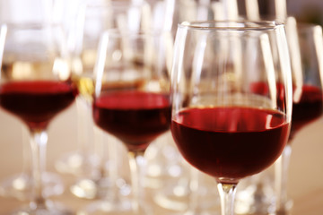Glasses with red and white wine on table in restaurant