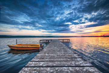 Fototapeta na wymiar Small Dock and Boat at the lake