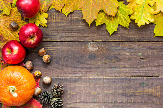 thanksgiving autumn fall background with pumpkin, leaves, apples and nuts