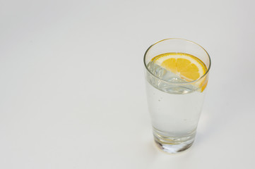Image of mineral water in glass on a light gray background