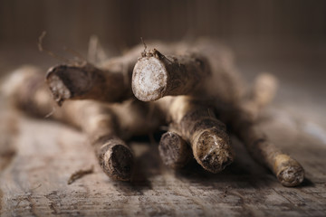 Roots of horseradish from the garden on a wooden table