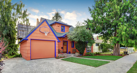 Coral exterior American house with blue trim with garage.