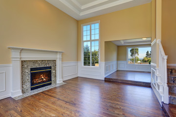 Open floor plan living room interior with hardwood floor and fireplace