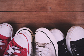 Old canvas shoes on a wooden floor Vintage Retro Filter.