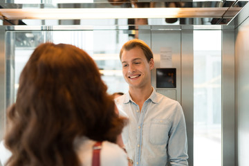 People talking in an elevator © Minerva Studio