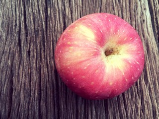 Red apple on wooden background vintage tone