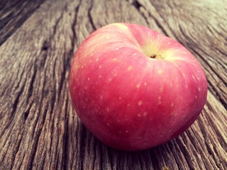 Red apple on wooden background vintage tone