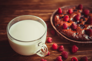 Fruit cake and cup of milk on the table.