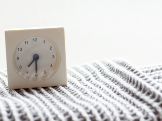 Series of a simple white analog clock on the blanket, 6/15