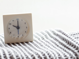 Series of a simple white analog clock on the blanket, 11/15