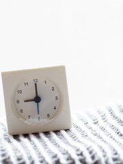 Series of a simple white analog clock on the blanket, 9/15