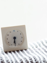 Series of a simple white analog clock on the blanket, 4/15