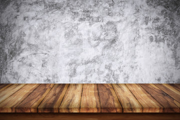 Empty wooden table with bare concrete wall background.