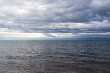 Naklejka na ściany i meble cloudy weather on the sea as background
