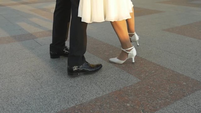 Male and female legs dancing tango