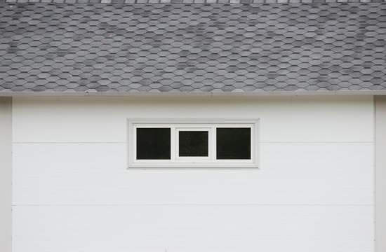 White wall texture house, dark windows, flexible brown tiles 