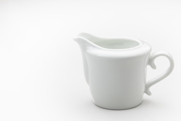 White ceramic creamer on a white background. - 121076108