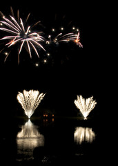 Fireworks display with reflections on the water