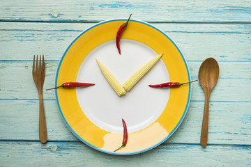 Food clock. Healthy food concept on wooden table