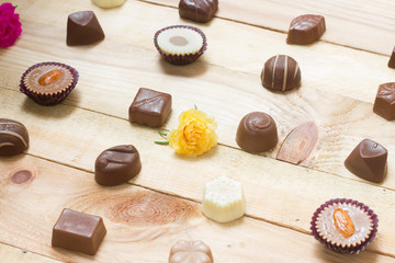 Chocolate candy set on wood background.