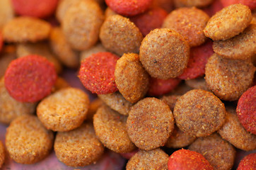 Closeup pile of fresh red and brown colored crunchy dog food