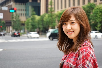 Young Asian woman smiling on the street in urban area
