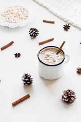 Christmas. Winter. Hot chocolate, cinnamon sticks, anise star, marshmallow, knitted blanket and cones. Christmas composition. Top view