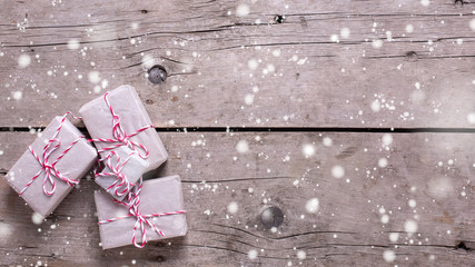 Wrapped christmas presents  on aged wooden background.