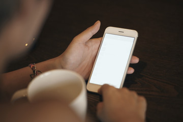 over shoulder closeup view of woman looking at mobile phone