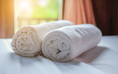 Obraz na płótnie Canvas Clean white towel roll lay on the couch.