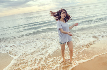 Fototapeta na wymiar Happy Woman relaxing in motion on the Beach nature. Beauty Girl Outdoor. Freedom concept. Enjoyment.