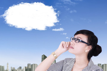 Asian woman looking at cloud