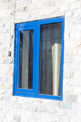 Fototapeta premium window in a brick building of granite