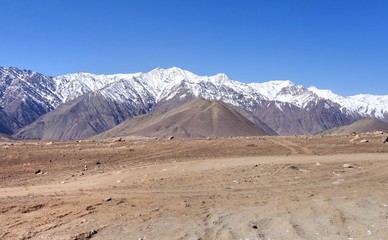 Fototapeta na wymiar Snow mountain range at road side viewpoint on the way to Khardung La from Leh LADAKH, INDIA
