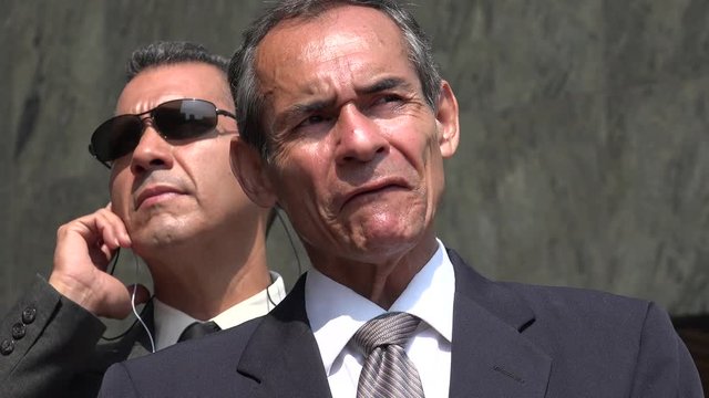 Politician Speaking With Bodyguard