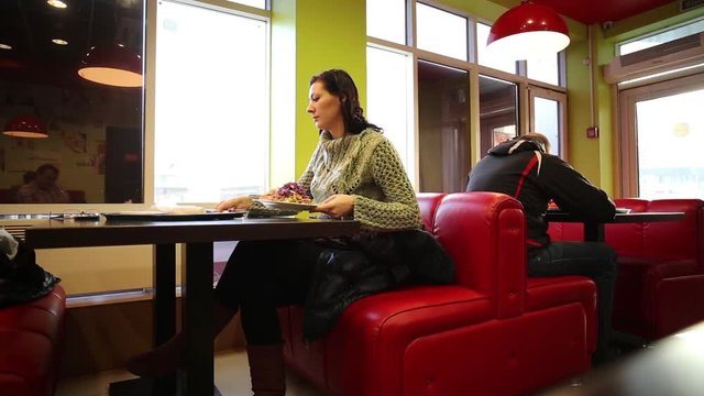 Woman In Cafe Eating Doner Kebab