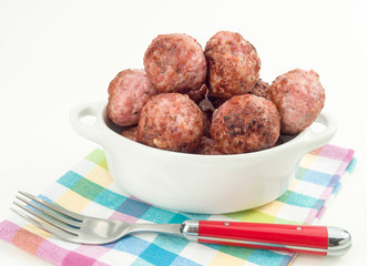 fried meatballs in porcelain pot, isolated