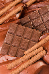 Ice-cream with chocolate and wafer rolls.