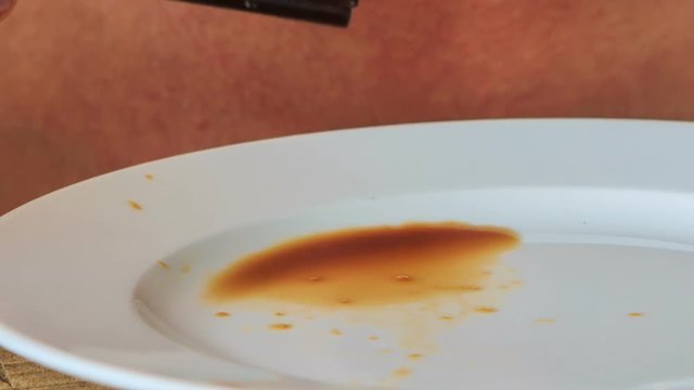 Closeup Man Takes Sushi with Sticks from Plate