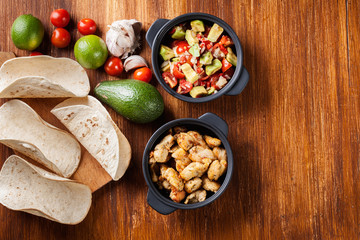 Ingredients ready for preparing chicken tacos with salsa made fr