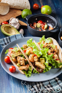 Authentic mexican tacos with chicken and salsa with avocado, tomatoes and chillies