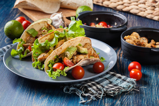 Authentic mexican tacos with chicken and salsa with avocado, tomatoes and chillies