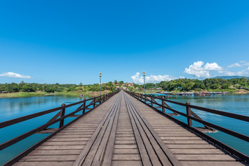 Fototapeta na wymiar Wooden bridge over the river (Mon Bridge) in Sangkhlaburi District, Kanchanaburi, Thailand.