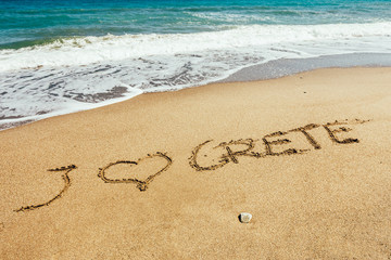 Crete inscription on the sand near the sea