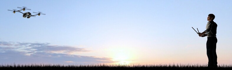 Man operating a drone at sunset using a controller - panorama © Riko Best