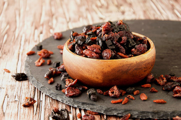 sliced dried fruits in a wooden bowl on the table