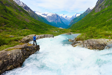 Fototapeta na wymiar Tourist woman by Videfossen Waterfall in Norway