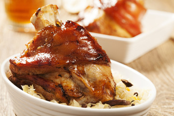Roast pork knuckle served with boiled cabbage, bread, horseradis