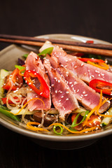 Grilled tuna and  asian rice glass noodles with vegetables